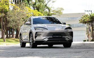 BYD Song Plus 2027 em destaque frontal, SUV híbrido plug-in com design moderno, faróis em LED e linhas aerodinâmicas em ambiente urbano arborizado