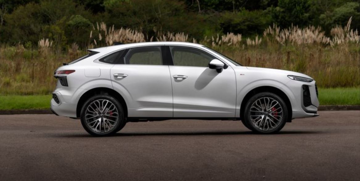 Novo Audi Q3 Sportback branco visto de perfil, destacando linhas esportivas, rodas de liga leve e silhueta elegante de SUV coupé.