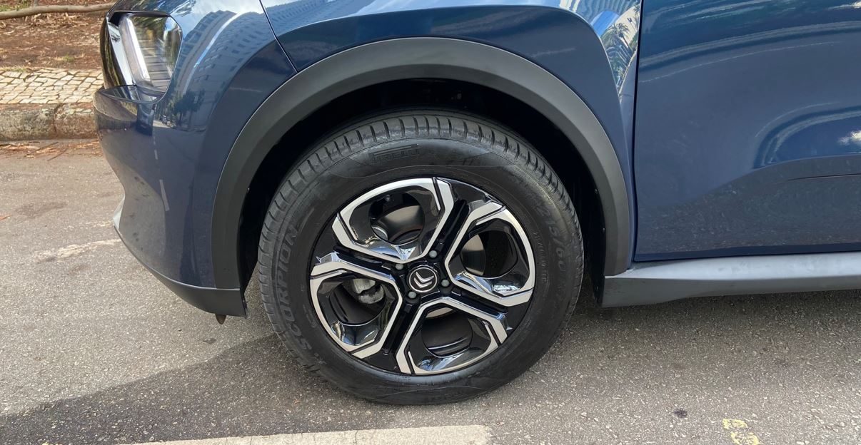 Detalhe da roda de liga leve do Citroën Aircross XTR 7 2026, com acabamento diamantado, moldura plástica no para-lama e pneu Pirelli Scorpion.