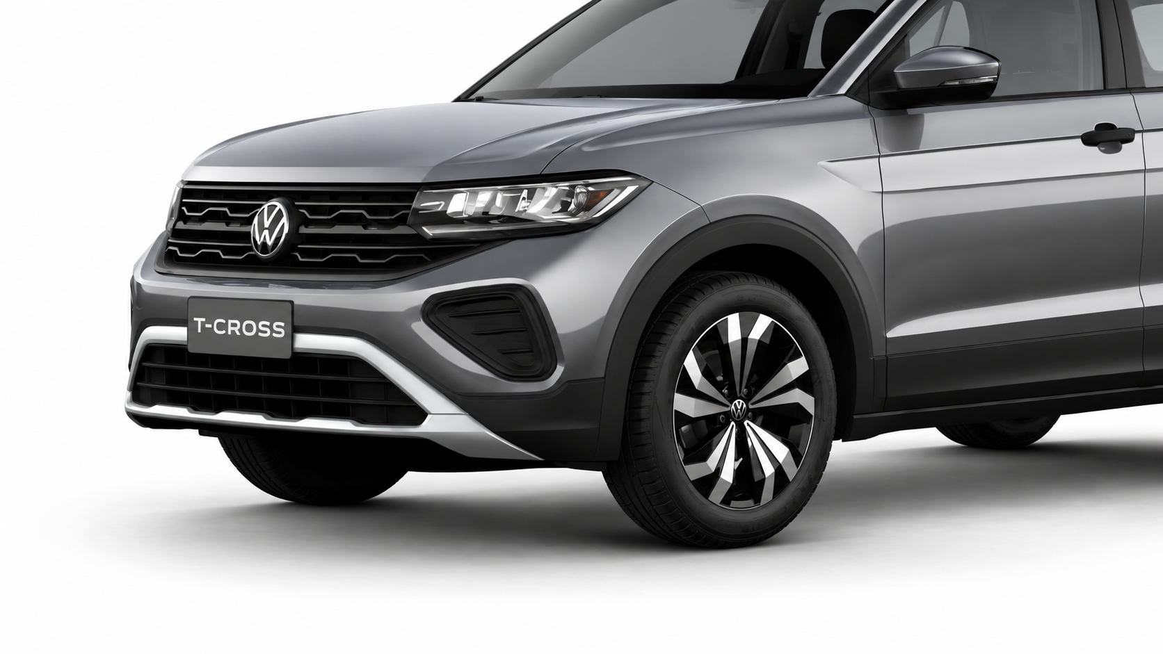 Detalhe frontal do Volkswagen T-Cross 2027 cinza, com grade, faróis, para-choque e roda de liga leve em destaque.