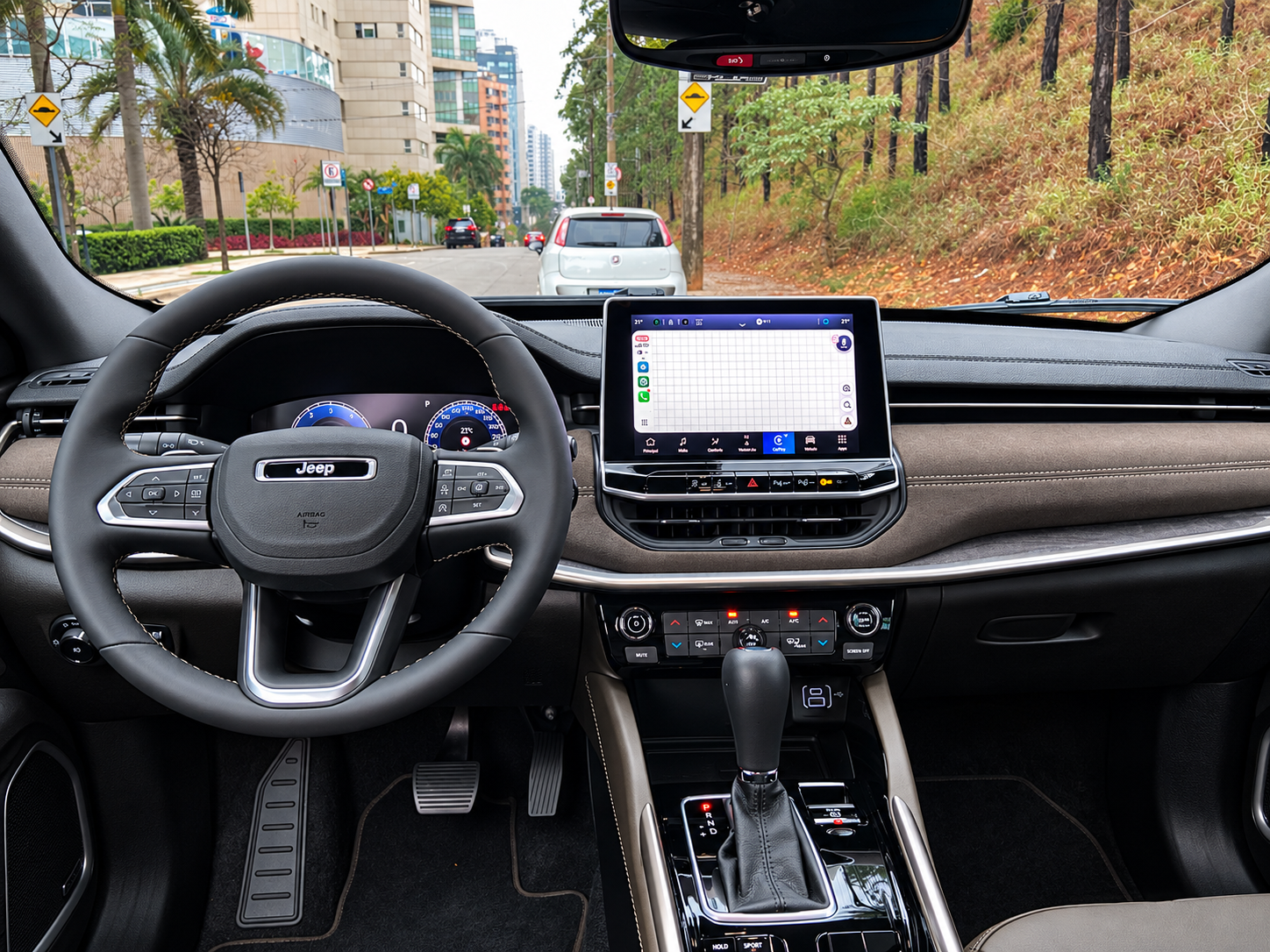 Painel do Jeep Commander 2027 com quadro de instrumentos digital, central multimídia, volante multifuncional e comandos do câmbio automático.
